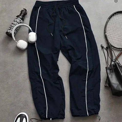 Men's lightweight casual fashion black sports pants with white stripes on the side, loose at the ankle, casual street style sports pants suitable for men and women couples, daily/street style, loose fit, windproof design