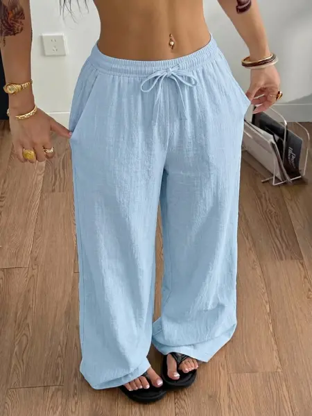 Women’s ultra-comfortable casual long pants made from polyester fiber, featuring side pockets, a drawstring elastic waistband, soft fabric, and drapey cuffs—an essential for summer.