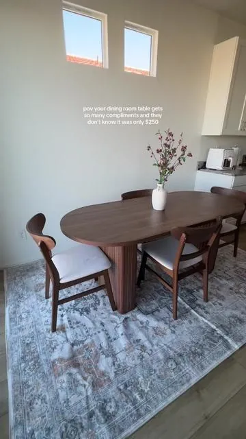 This table is our most complimented piece of furniture we bought for our new home! The walnut color and fluted wood gives luxury, but on a budget. It’s the perfect size for our family and small dining room space. #diningroom #homedecor #homeinspo #newhome #newbuildhomes 