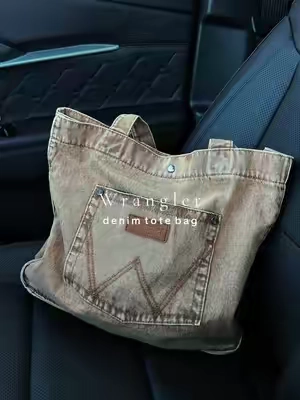 The cutest denim bag 🤎 @Rustic Charm Bootic #purse #pursetok #shoulderbag #wranglerpurse #denimbag 