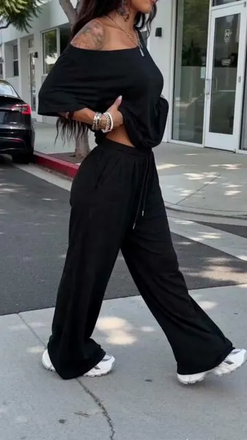 "The only two-piece set you need for that effortless street-style look. 🖤 Oversized off-the-shoulder tee + flowy wide-leg pants. Supreme comfort, zero effort. Black, Brown, or Navy? Grab your set below! ✨☕️" #StreetStyleVibes #TwoPieceSet #EffortlessOutfit #LoungewearToStreetwear #ComfyFashion     