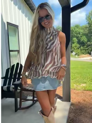 The taupe zebra and the ruffles are you kidding!!!!🤎 I’m obsessed with all of the layers in this top! So cute and the best quality too #tiktokshopcreatorpicks #flowytop #ruffletop #countryconcertoutfit #gamedayoutfit 