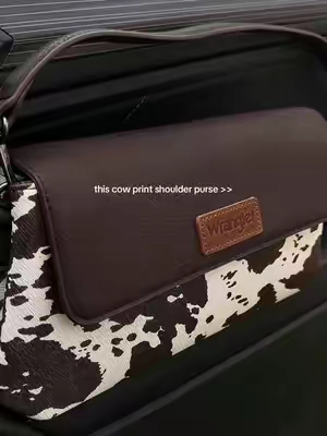 brand new shoulder bag from Wrangler and this cow print design is perfect #wrangler #wranglerpurse #westernfashion #pursetok 